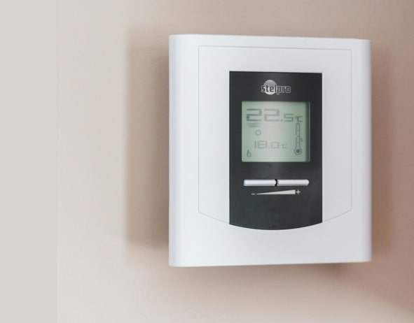 Smart thermostat on wall